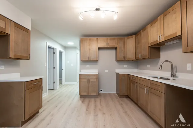 an empty room with wooden floor ceiling fan and window