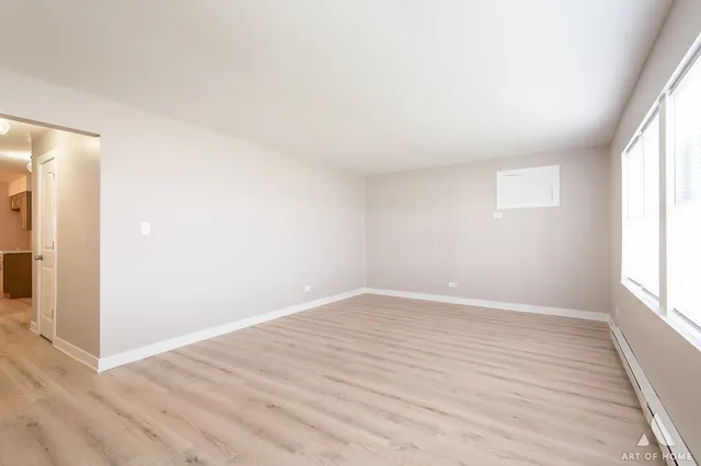 a view of a living room with a bed and a lamp