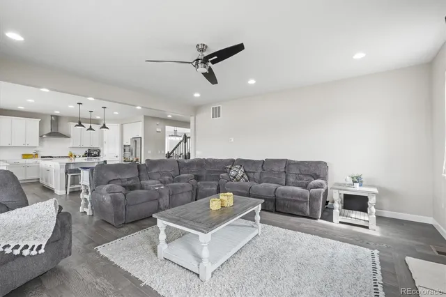 a balcony with furniture and wooden floor