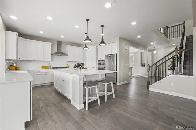 a front view of a house with a garden and mountain view