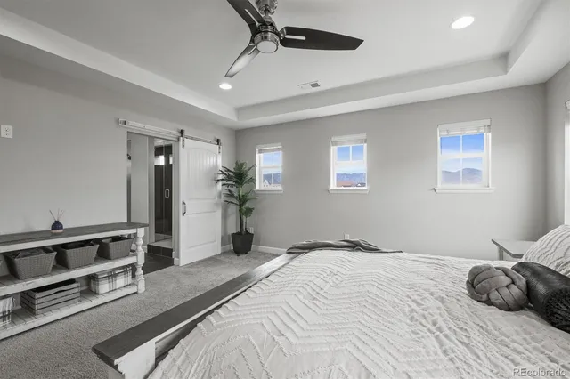 a bedroom with a bed couch and window