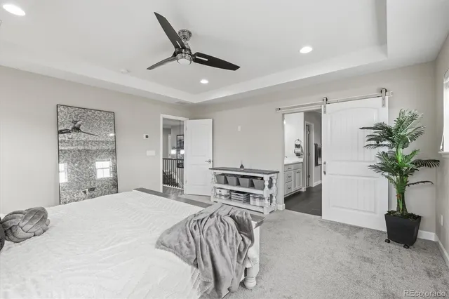 a bedroom with a bed and glass walk in closet