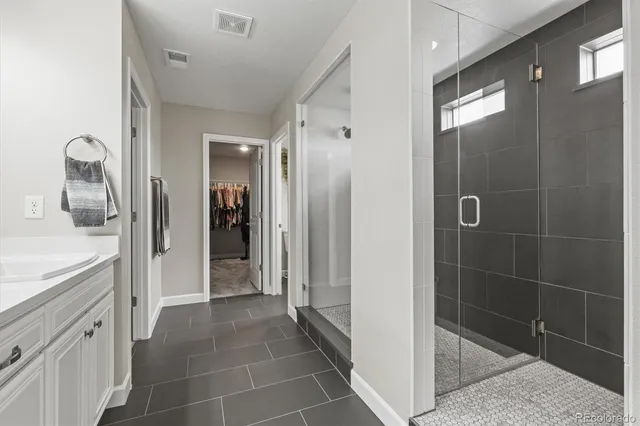 a bathroom with a shower a toilet and a sink