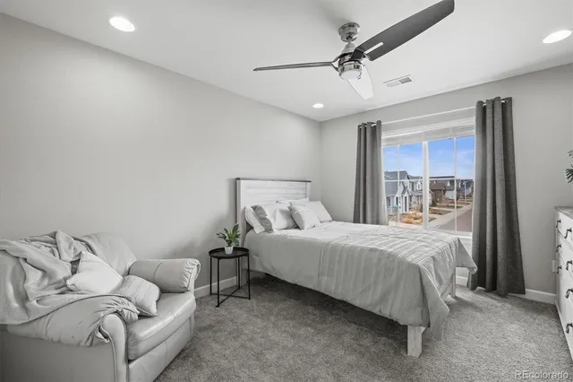 a bedroom with a bed and a lamp