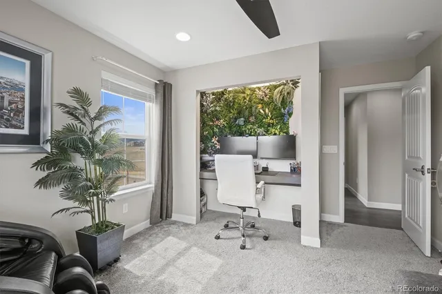 a bedroom with a bed and a potted plant