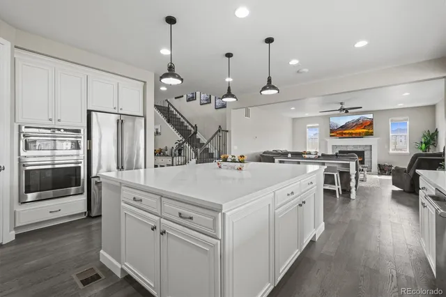 a kitchen with cabinets appliances a sink and a counter top space