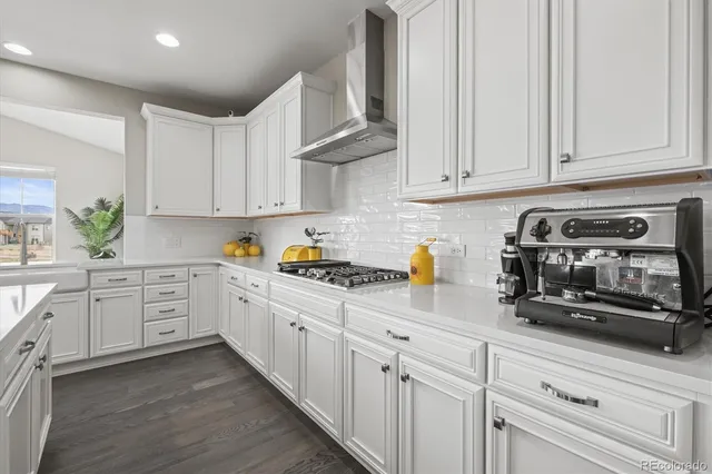 a living room with furniture cabinets and a window