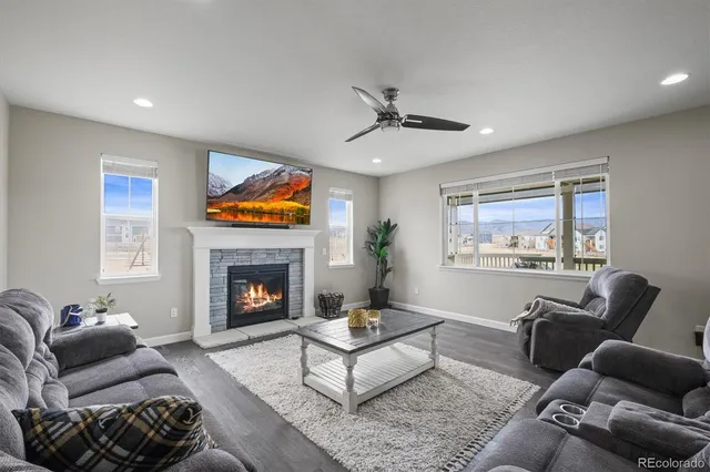 a living room with furniture and a view of kitchen