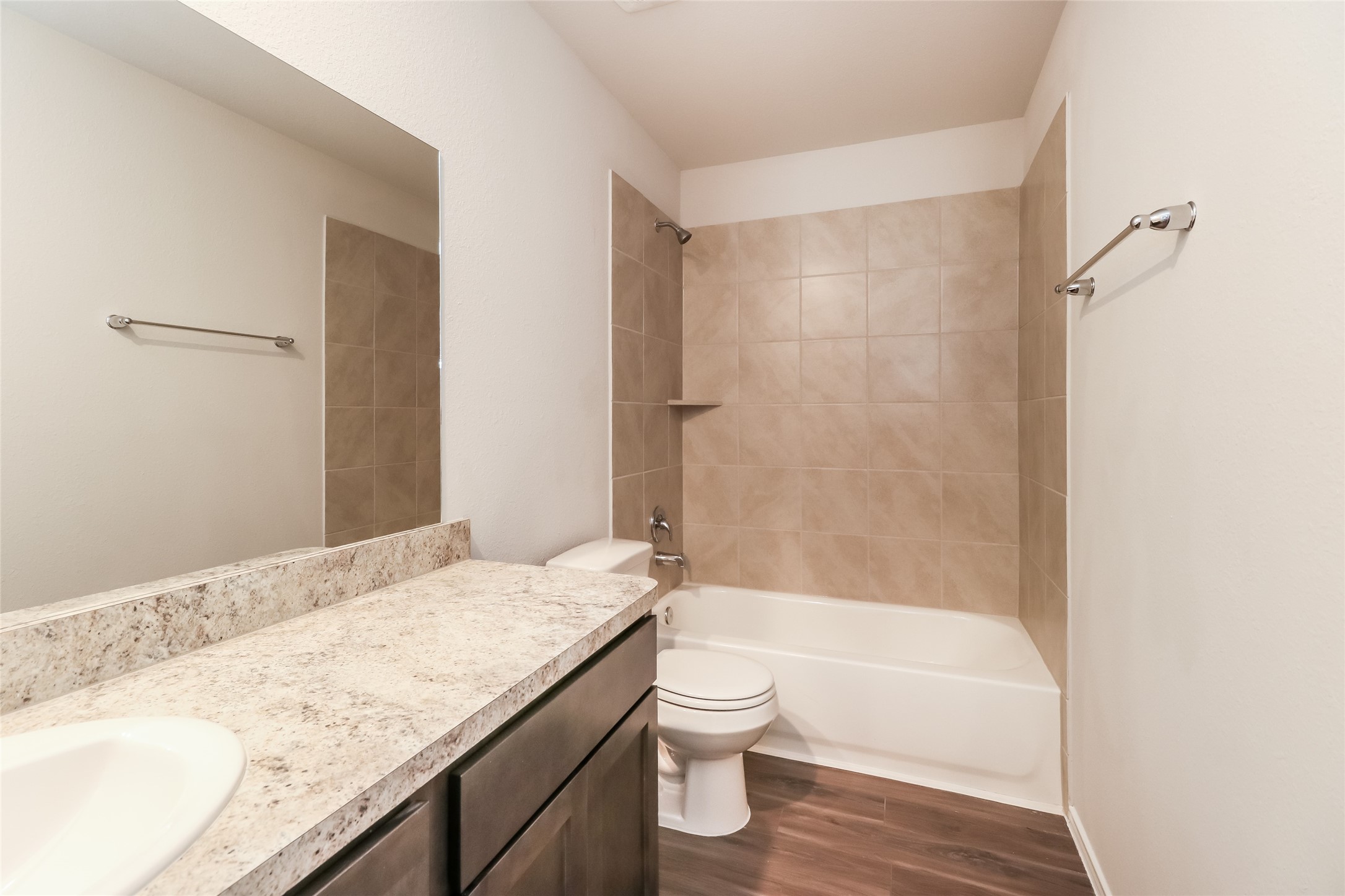 2465 Carp Drive Conroe, TX 77384 - Photo 12 of 18 a bathroom with a granite countertop bathtub shower sink vanity and toilet