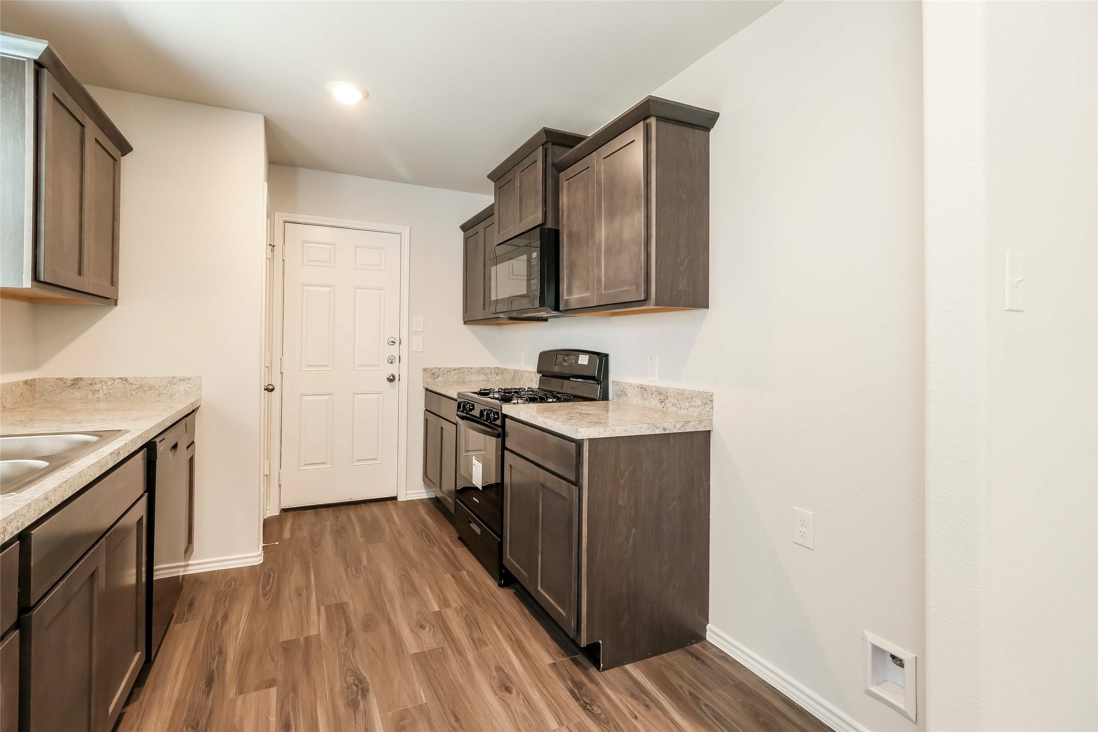 2465 Carp Drive Conroe, TX 77384 - Photo 8 of 18 a kitchen with a sink and a stove top oven