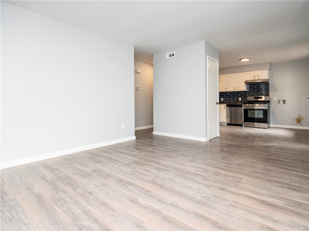 7004 Circle S Road, Unit B Austin, TX 78745 - Photo 6 of 12 A seamless open-concept design transitions from the living area to a sleek, modern kitchen.