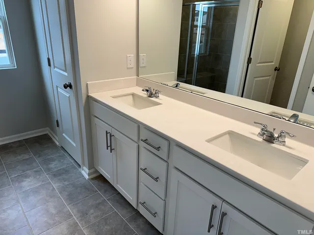 a bathroom with a glass shower door