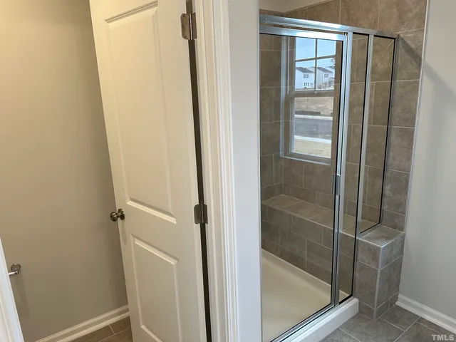 a white toilet sitting next to a shower