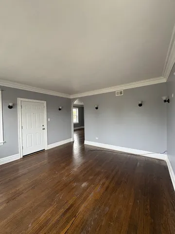 a view of an empty room and wooden floor