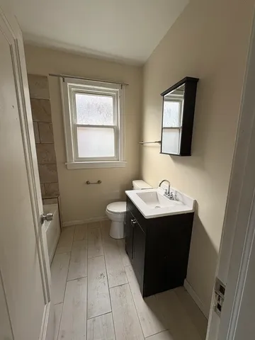 a bathroom with a sink toilet and mirror