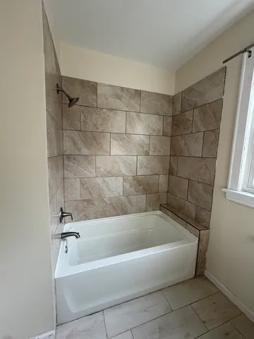 a white bath tub sitting in a bathroom