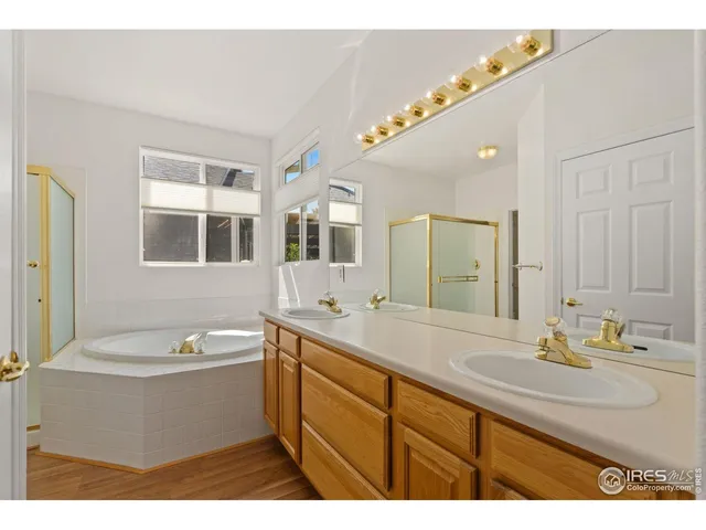a bathroom with a sink mirror and a bathtub
