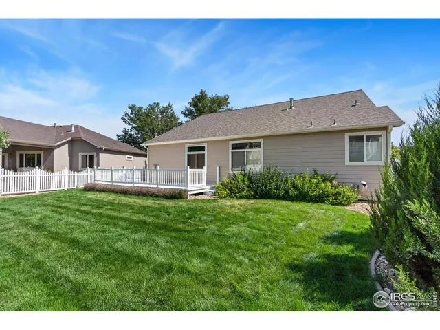 a aerial view of a house with a yard table and chairs