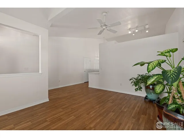 a view of an empty room and wooden floor