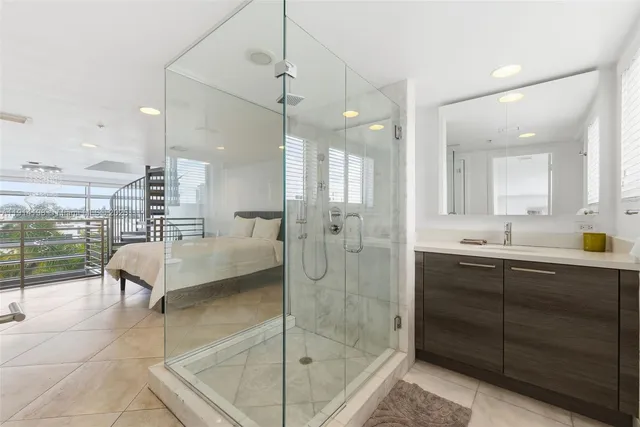 a bathroom with a double vanity sink mirror and shower