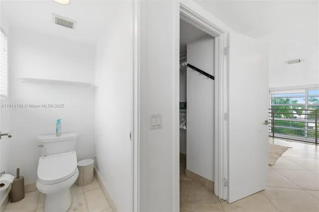 a white toilet sitting next to a bathroom sink