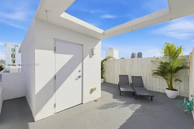 a living room with furniture and potted plant