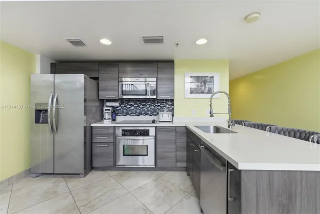 a kitchen with stainless steel appliances granite countertop a sink and cabinets