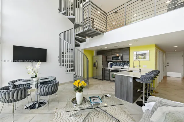 a view of a livingroom with furniture and a flat screen tv