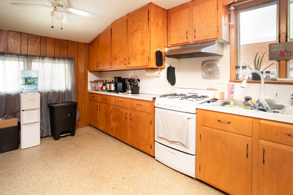 828-830 Stafford Road Fall River, MA 02721 - Photo 19 of 30 a kitchen with stainless steel appliances granite countertop a stove a sink dishwasher and a refrigerator
