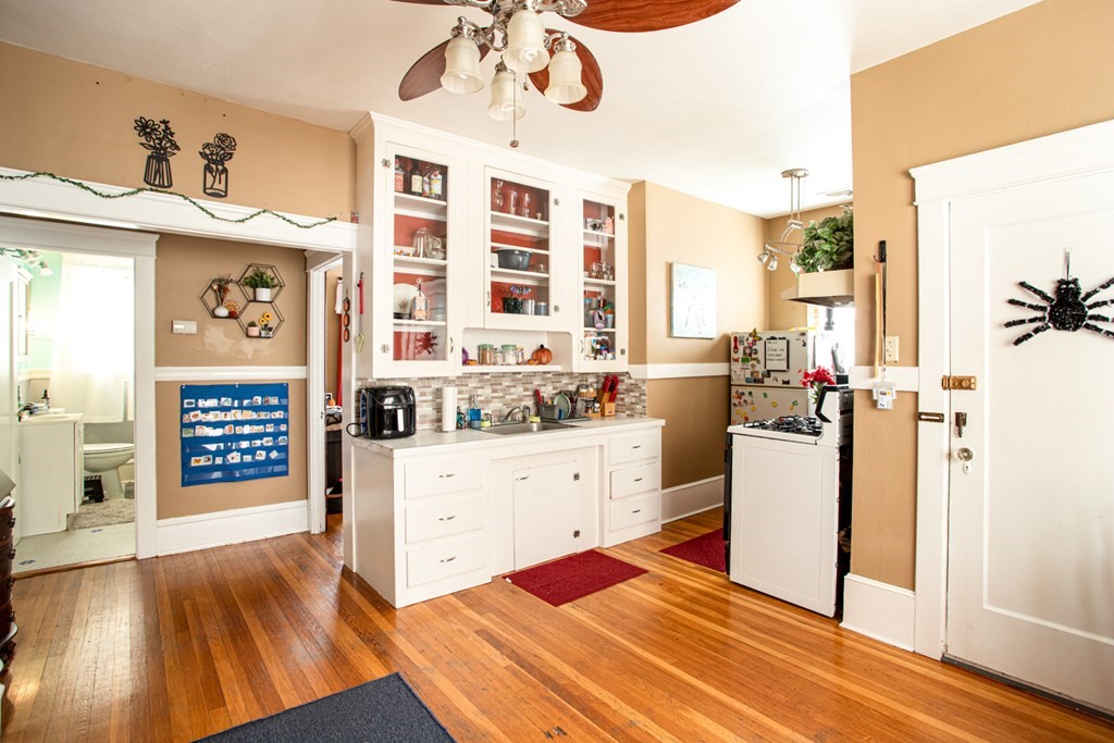 828-830 Stafford Road Fall River, MA 02721 - Photo 8 of 30 a kitchen with stainless steel appliances kitchen island wooden floors and white walls