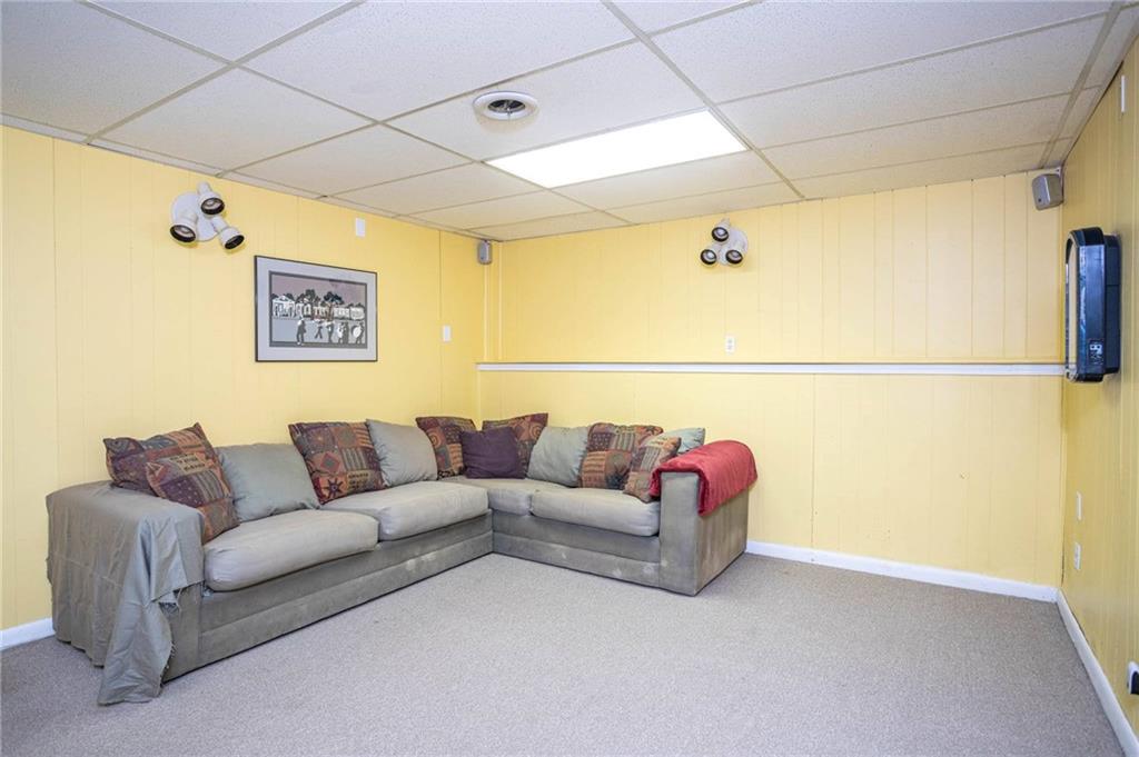3838 Hunting Ridge Drive Southwest Lilburn, GA 30047 - Photo 46 of 56 a living room with a couch and a ceiling fan