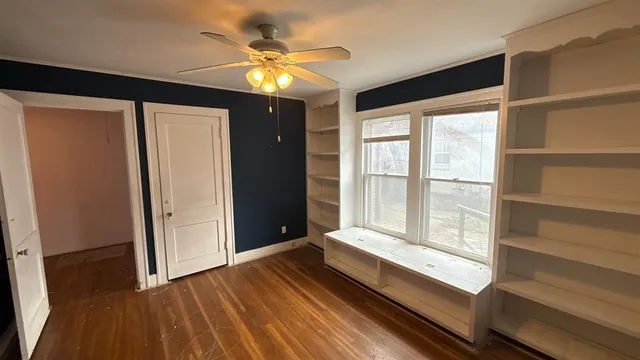 a view of room with window and wooden floor