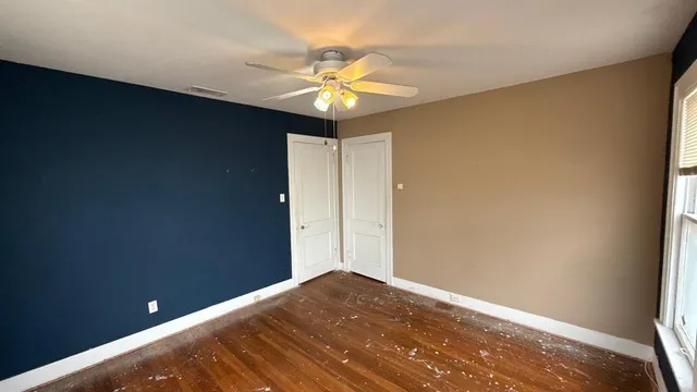 a view of a hallway with a chandelier fan