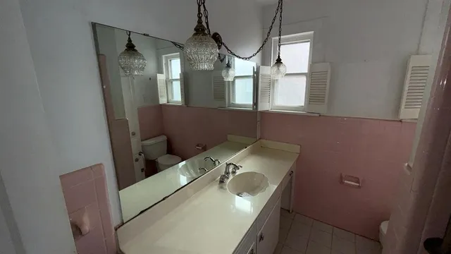 a bathroom with a sink and mirror
