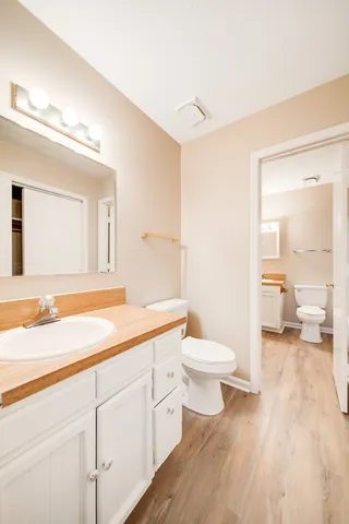 a spacious bathroom with a toilet sink and a mirror