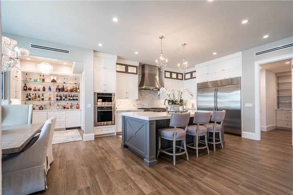 2349 Northeast 24th Street Lighthouse Point, FL 33064 - Photo 13 of 85 a large kitchen with a table and chairs