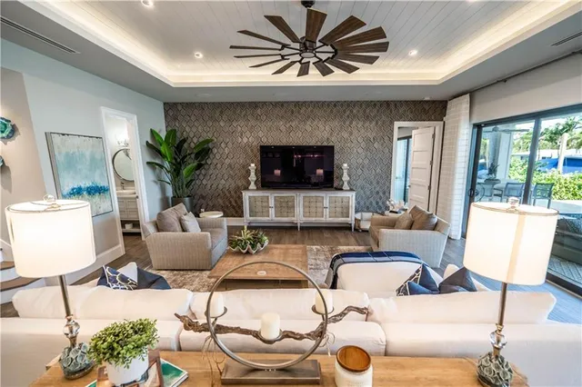 a living room with furniture and a floor to ceiling window