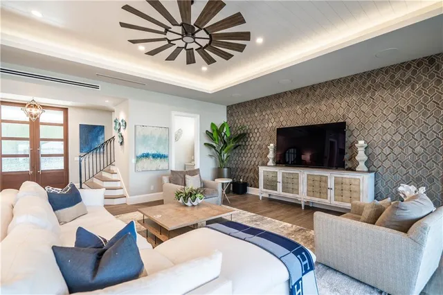 a living room with patio furniture and a floor to ceiling window