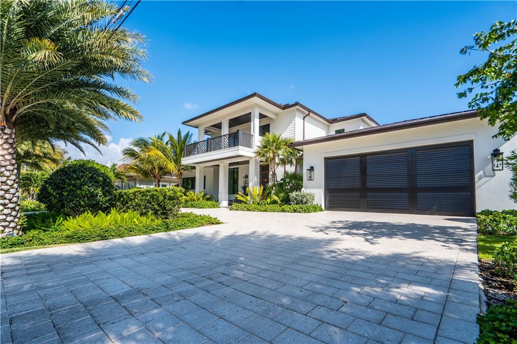 2349 Northeast 24th Street Lighthouse Point, FL 33064 - Photo 2 of 85 a front view of a house with a yard and garage