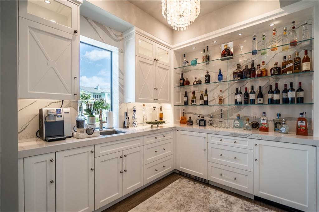 2349 Northeast 24th Street Lighthouse Point, FL 33064 - Photo 21 of 85 a kitchen with white cabinets and sink