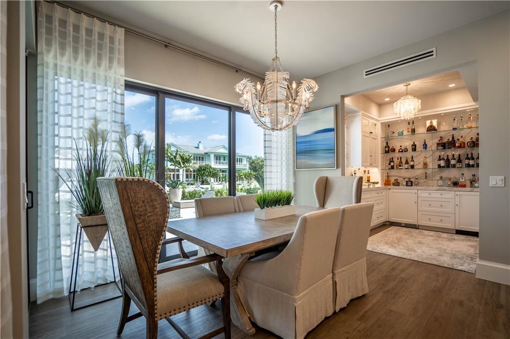 2349 Northeast 24th Street Lighthouse Point, FL 33064 - Photo 22 of 85 a view of a dining room with furniture a chandelier and wooden floor