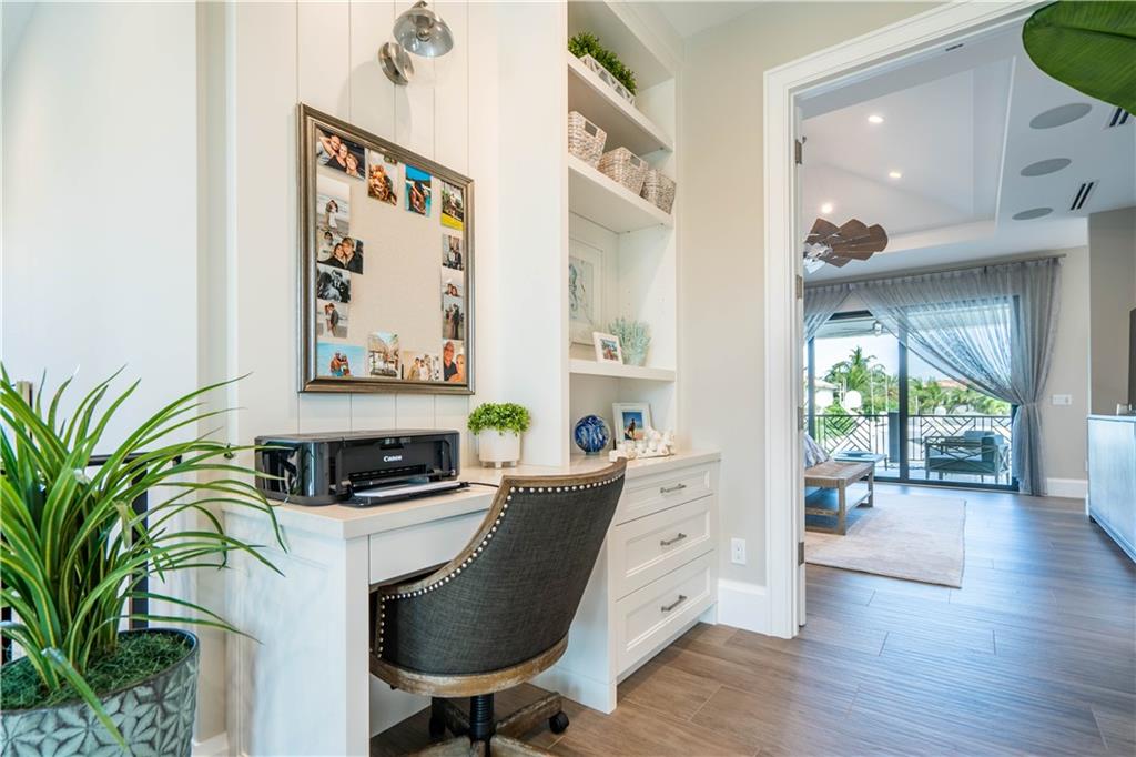 2349 Northeast 24th Street Lighthouse Point, FL 33064 - Photo 29 of 85 a view of a workspace with furniture and a potted plant