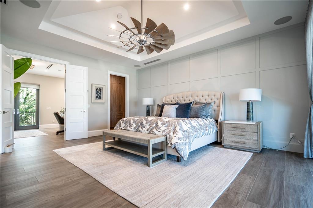 2349 Northeast 24th Street Lighthouse Point, FL 33064 - Photo 33 of 85 a bedroom with a bed and a chandelier