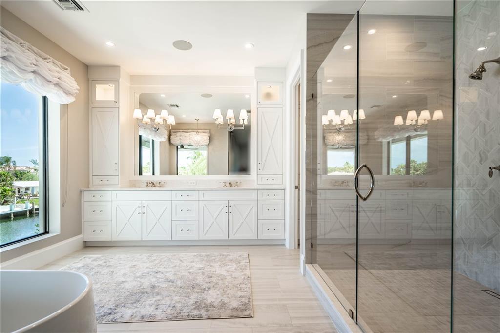 2349 Northeast 24th Street Lighthouse Point, FL 33064 - Photo 37 of 85 a large bathroom with a glass shower door