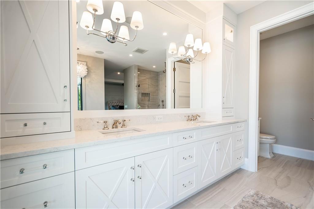 2349 Northeast 24th Street Lighthouse Point, FL 33064 - Photo 38 of 85 a bathroom with a sink vanity and a mirror