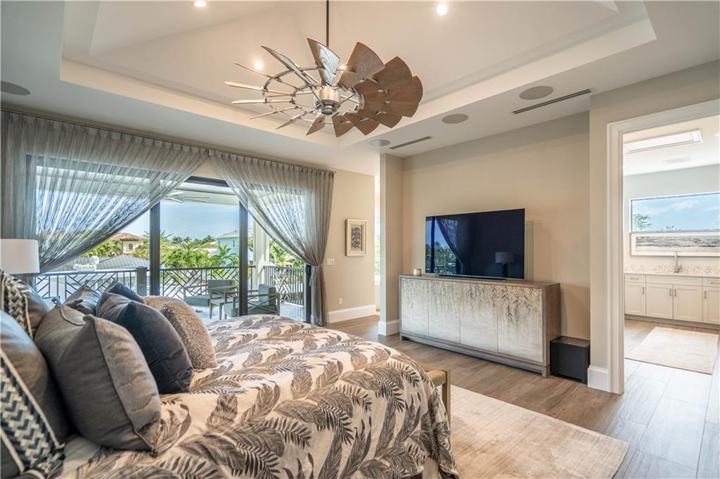 2349 Northeast 24th Street Lighthouse Point, FL 33064 - Photo 41 of 85 a bedroom with a large bed and a flat tv screen on dresser