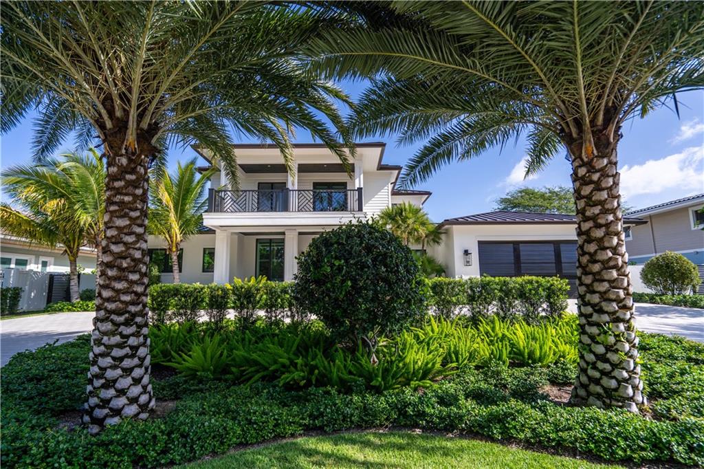 2349 Northeast 24th Street Lighthouse Point, FL 33064 - Photo 5 of 85 a front view of a house with a garden