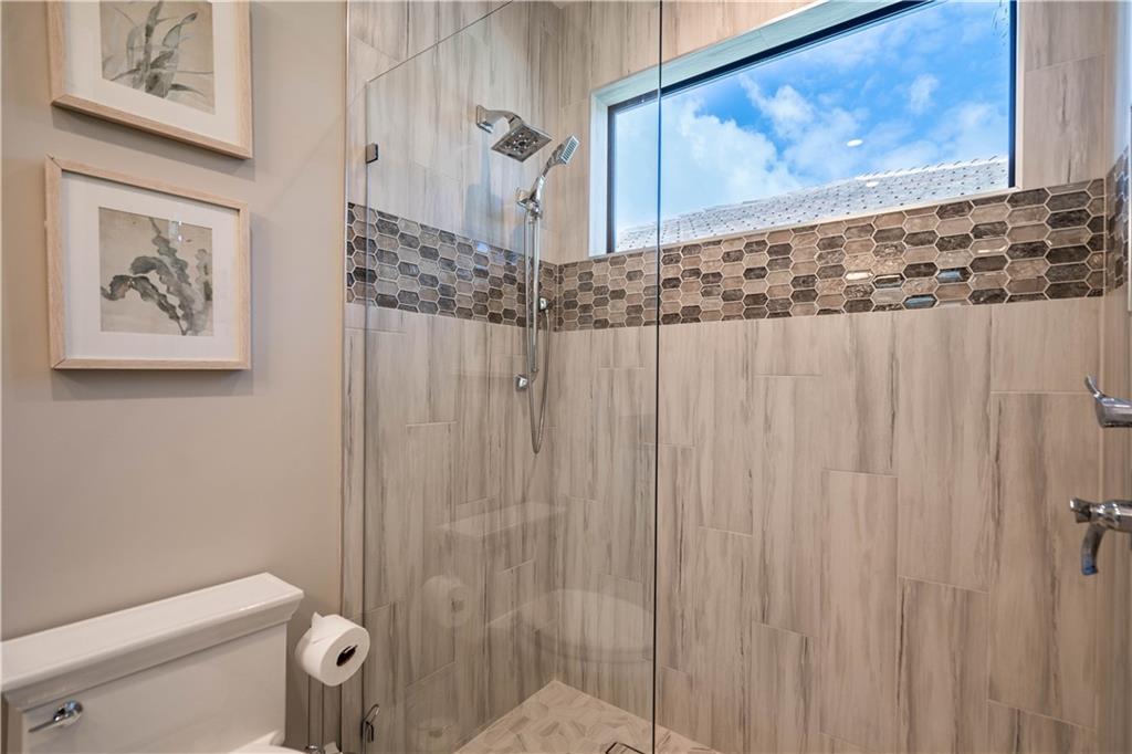 2349 Northeast 24th Street Lighthouse Point, FL 33064 - Photo 54 of 85 a bathroom with a shower and a toilet