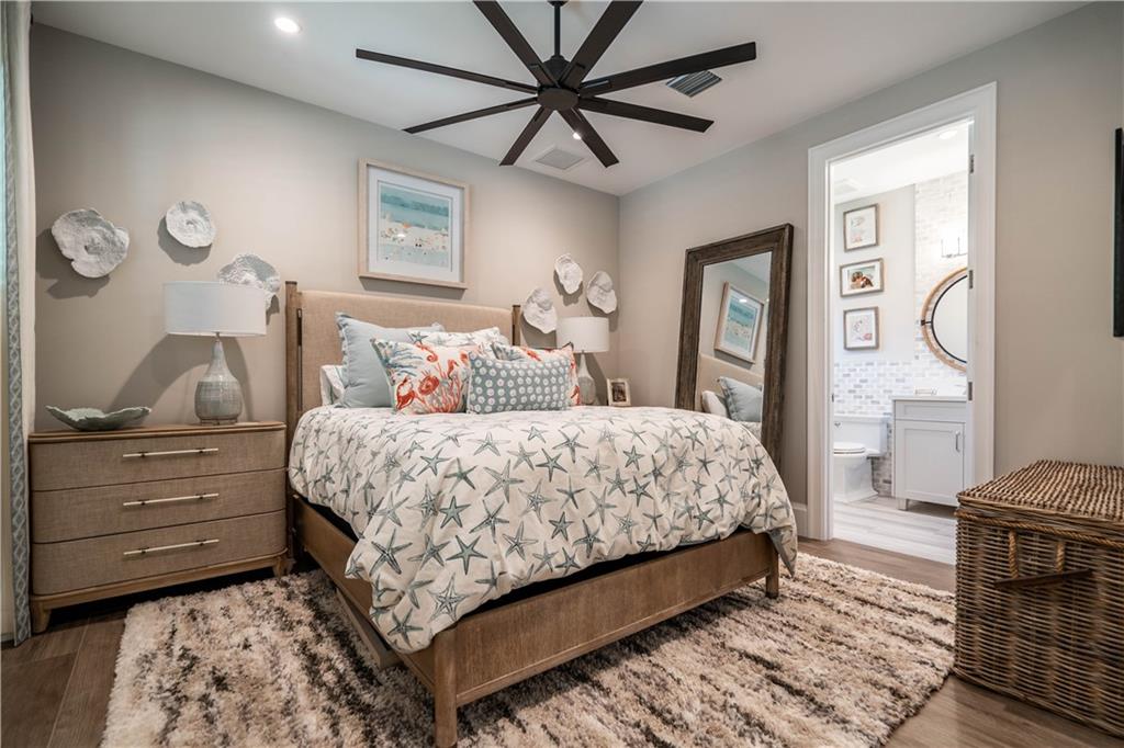 2349 Northeast 24th Street Lighthouse Point, FL 33064 - Photo 56 of 85 a bedroom with a bed and a chandelier