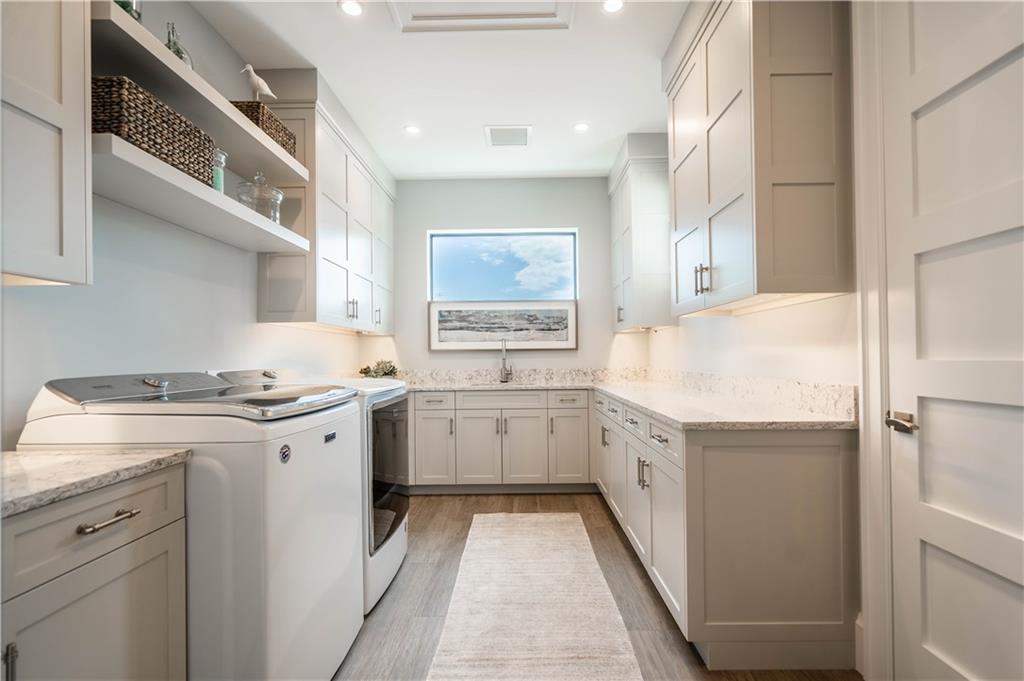 2349 Northeast 24th Street Lighthouse Point, FL 33064 - Photo 60 of 85 a kitchen with granite countertop cabinets and white appliances